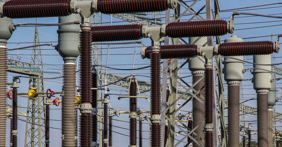 Detailed view of high voltage electrical substation with transformers and power lines.